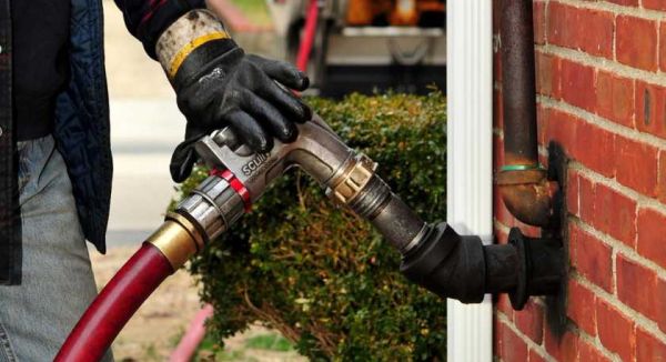 Domino Fuel driver completing a cash on delivery heating oil order on Long Island